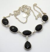 A silver and black onyx necklace, five oval panels with pear cut suspended below, stamped 925.