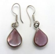 A pair of mother of pearl drop earrings.