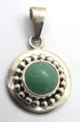 A silver and jade pendant of roundel form, stamped Mexico 925, 39mm inc bale.