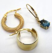Three single 9ct gold earrings, weight of two hoops combined 1.3g.