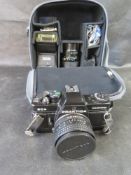 A Praktica camera with lense and flash in bag.