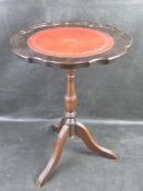 A leather topped wine table with tripod base