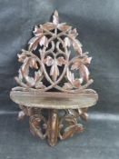 A black forest type carved wooden shelf.