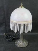 A contemporary table lamp with 1930s style glass shade.