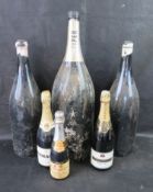 A quantity of oversized display champagne bottles together with three bottles of alchol