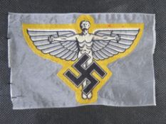 A reproduction WWII German NSFK cloth shirt insignia
