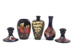 A group of modern Moorcroft wares including a pair of candlesticks in the Anemone pattern, small