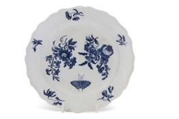 An 18th Century rare plate with shaped rim and printed with floral sprays and butterflies in pale