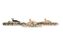 Three 19th Century Greyhound Desk Weights; Probably Minton each raised on oval pads on flower