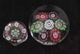 BACCARAT AND CLICHY PAPERWEIGHTS, the Baccarat example with seven multi-coloured flowerheads the