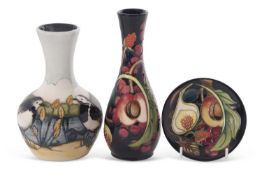 A group of three modern Moorcroft wares including a vase in the Queens Choice pattern, further