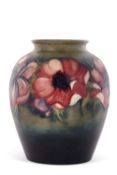 A large Moorcroft vase mid 20th Century decorated with Anemones on a graduated green ground with