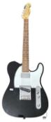 A Fender Squier Telecaster 20th anniversary electric guitar in black with white scratchplate and