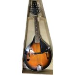 An Encore Falcon 8-string mandolin in orange sunburst