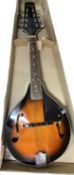 An Encore Falcon 8-string mandolin in orange sunburst