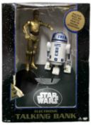 A boxed Star Wars electronic talking money bank, featuring C-3PO and R2-D2
