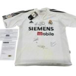 A Real Madrid football shirt, bearing the signatures of Owen, Figo, Zidane, and Ronaldo, with COA.