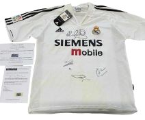 A Real Madrid football shirt, bearing the signatures of Owen, Figo, Zidane, and Ronaldo, with COA.