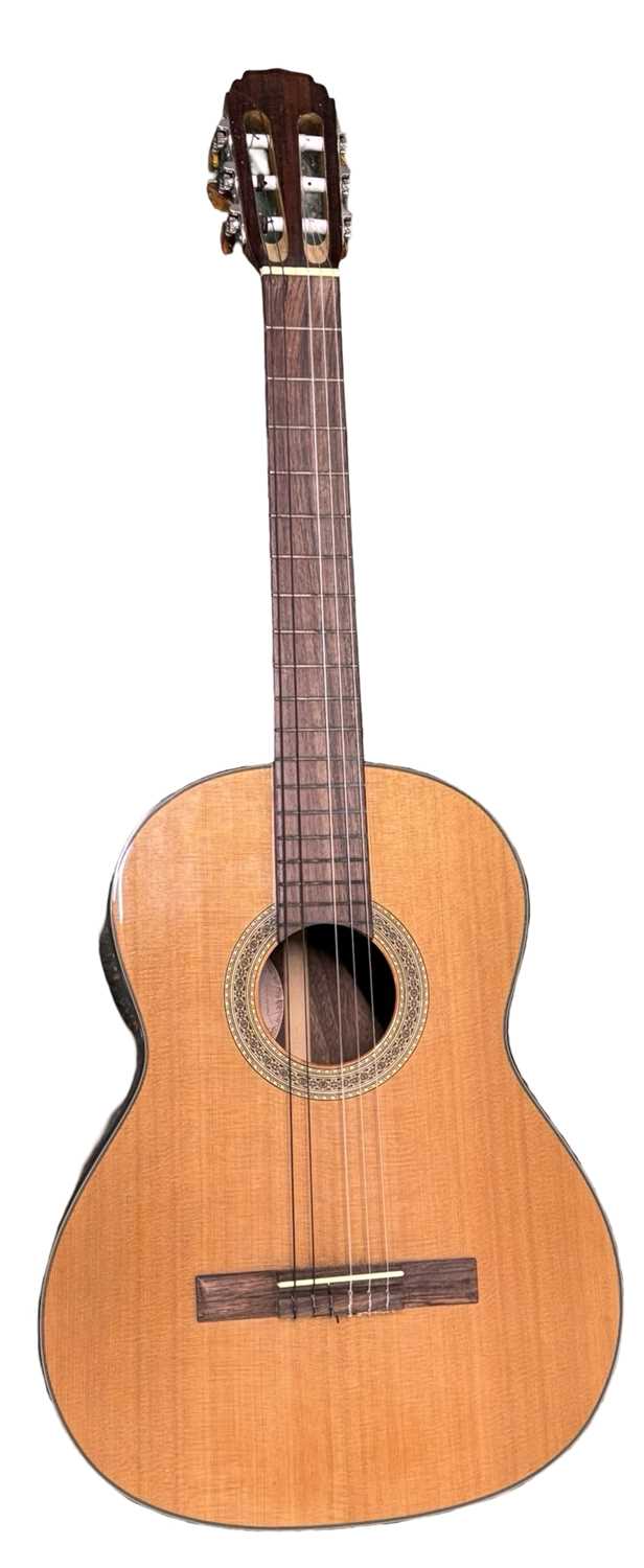 A Cort 6-string acoustic guitar, model number: AC-15-NAT, serial number: CA04095483