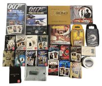 A mixed lot of various James Bond playing cards, soundtrack CDs, keyring/pin badge etc