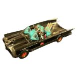 A die-cast Corgi Batmobile with original figures