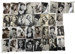 A collection of various black and white postcard fim stills and headshots, some bearing facsimile