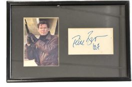 A framed and glazed photograph and autographs of Pierce Brosnan as James Bond. Frames size