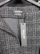 Isabel De Pedro: A black tweed printed two piece suit of trousers and V neck top, together with a