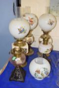 Quantity of various oil lamps and shades