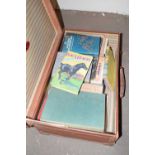 Vintage suitcase containing various books