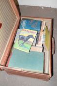 Vintage suitcase containing various books