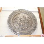 A large decorative metal platter