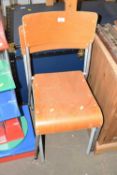 Two wood and metal stacking chairs