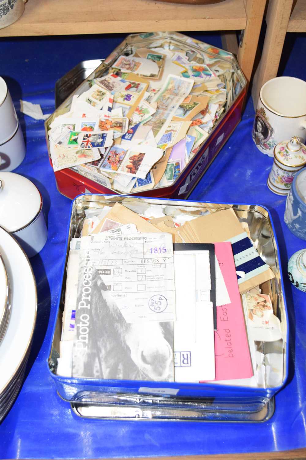 Two tins of used stamps