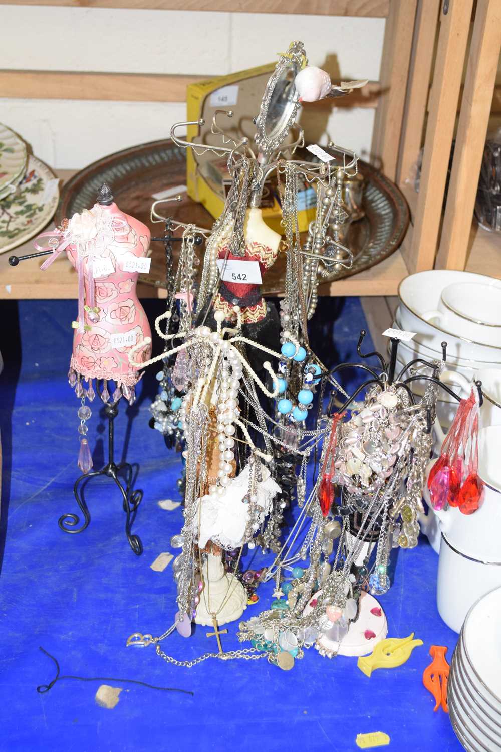 Various necklaces contained on necklace stands