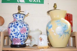 Two large table lamp bases together with two floral decorated glass shades