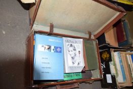 Vintage suitcase containing various books