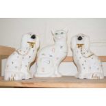 A pair of Staffordshire style dogs together with a cat