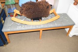 An upholstered long stool