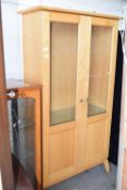 Tall glazed display cabinet