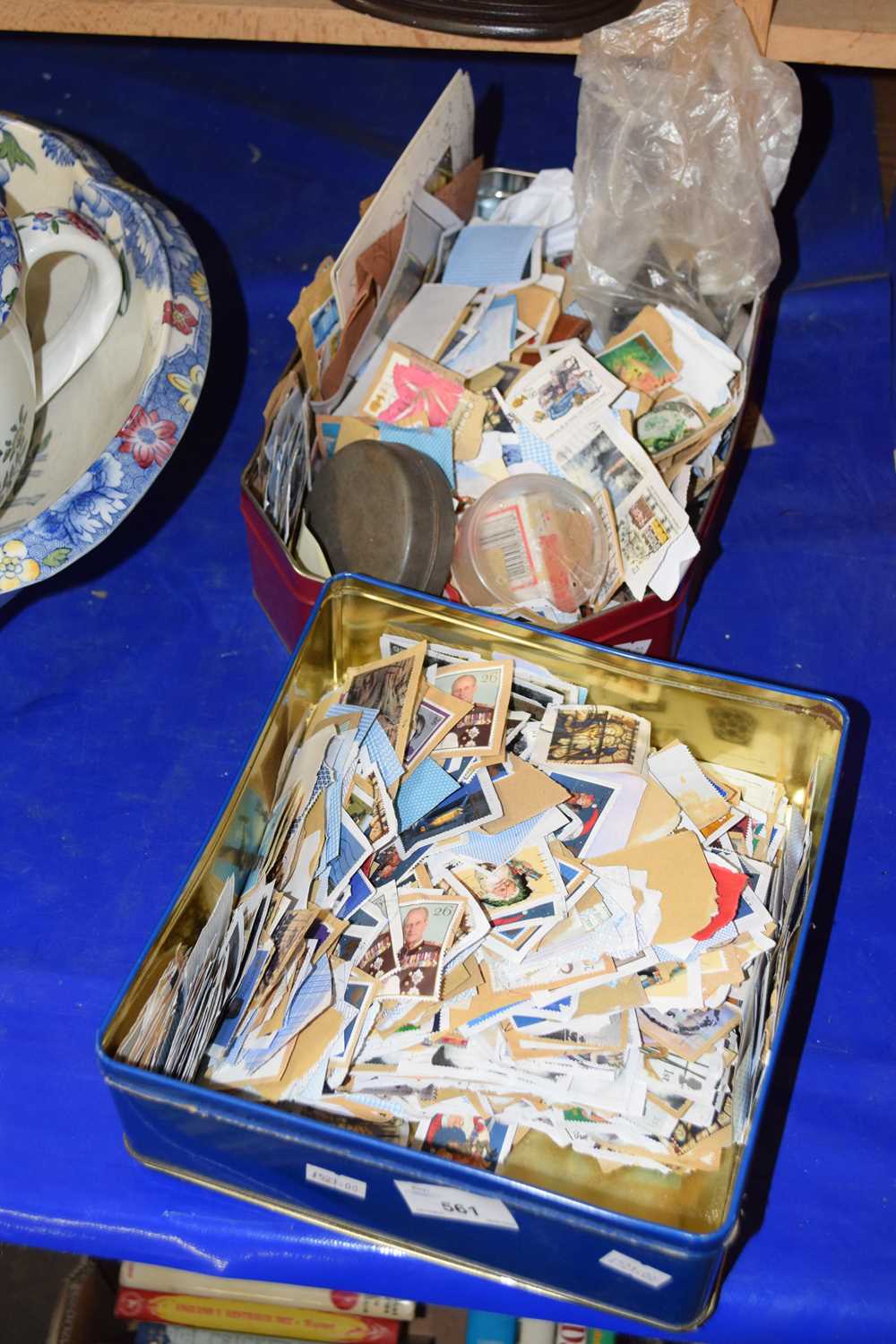 Two tins of various stamps and other items