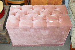 A pink velvet button top storage bench