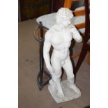 A resin garden statue together with a vintage metal umbrella stand