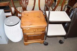 A pine bedside cabinet together with a clothes bin and a wheeled trolley