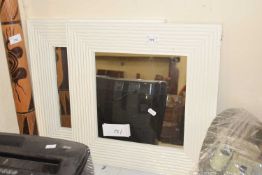 Two small white framed mirrors