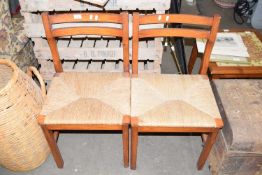 A pair of rush seat dining chairs