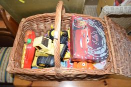 Picnic basket containing a quantity of assorted vintage plastic toys