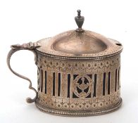 A George III silver large mustard pot and blue glass liner of oval form, the body pierced all around