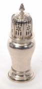 George V silver caster of plain tapering baluster form, having a pull-off pierced cover with