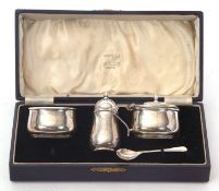 A cased George VI silver condiment set to include mustard and liner, pepper and open salt and